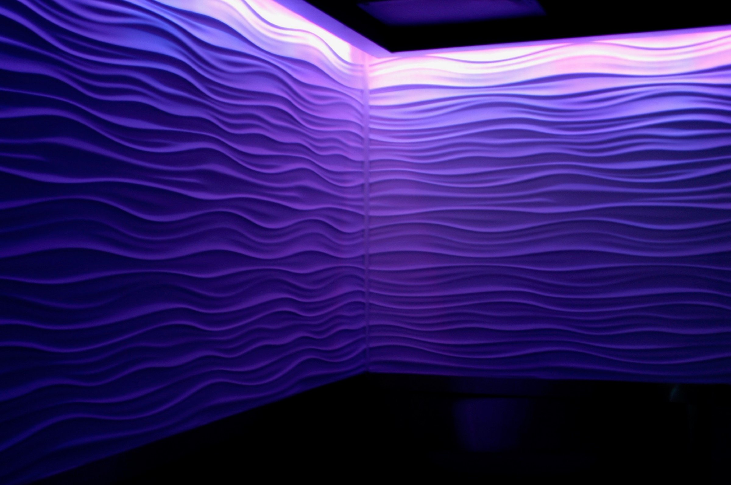 Illuminated wave wall detail at Blue Bar