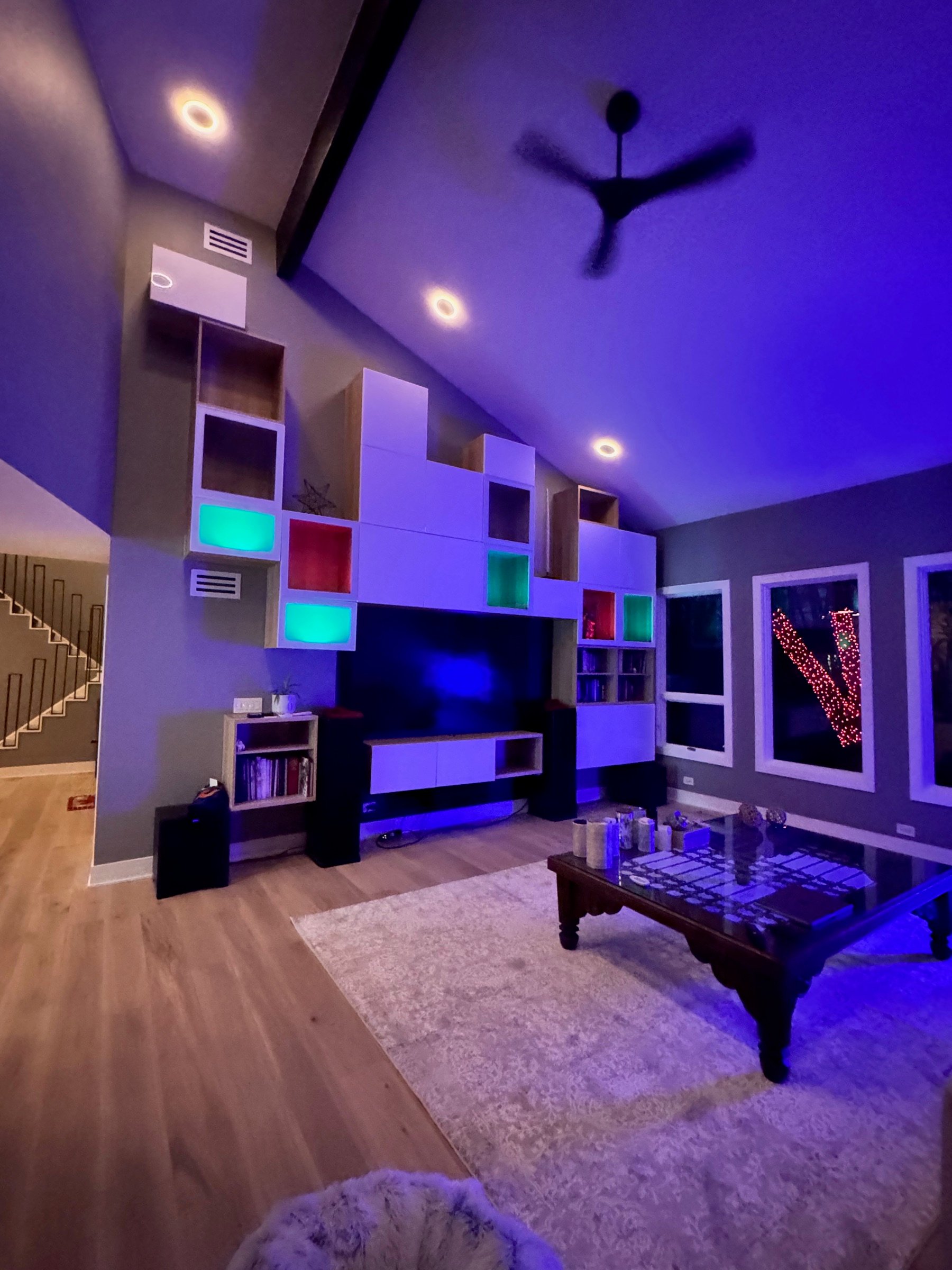 Built-in shelving wall with integrated color and storage at Robinwood