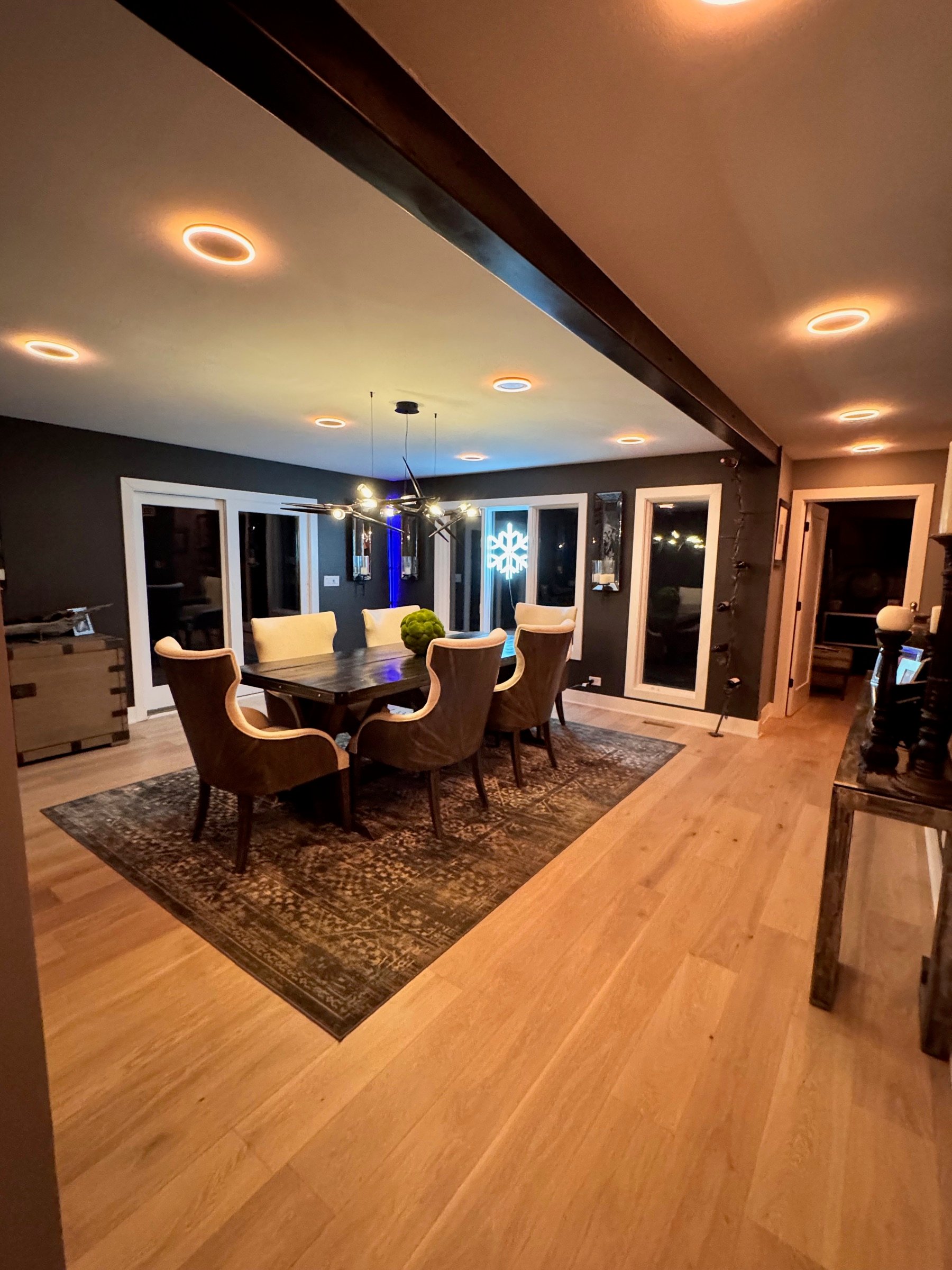 Dining room and kitchen composition opening into one another