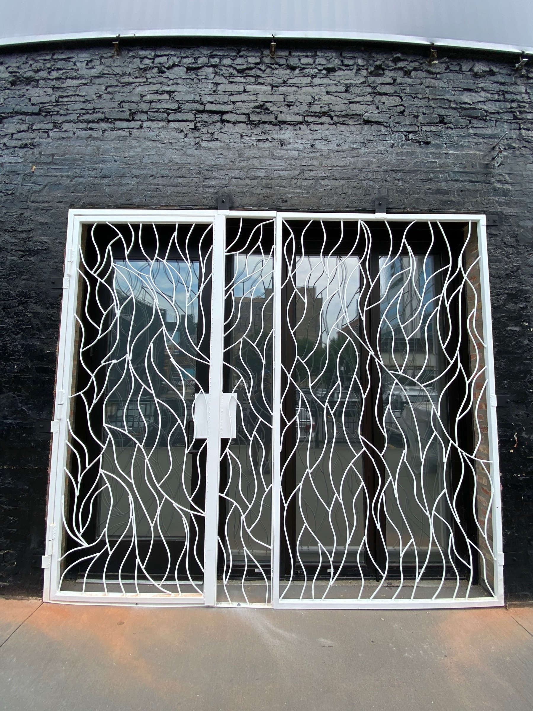 Angled exterior view of the Moca storefront and vine-pattern ironwork