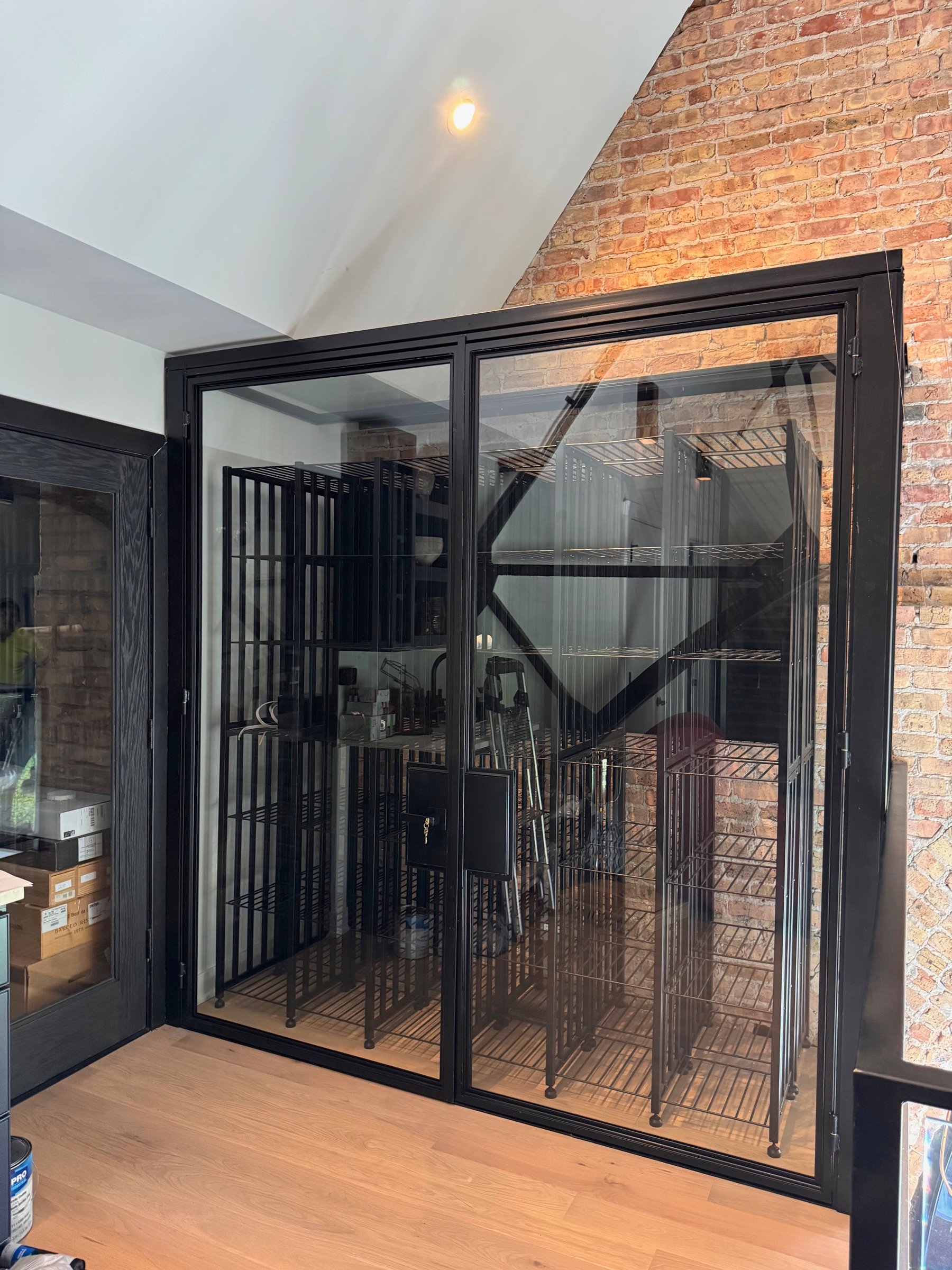 Glass panel and wine rack detail behind the cellar doors