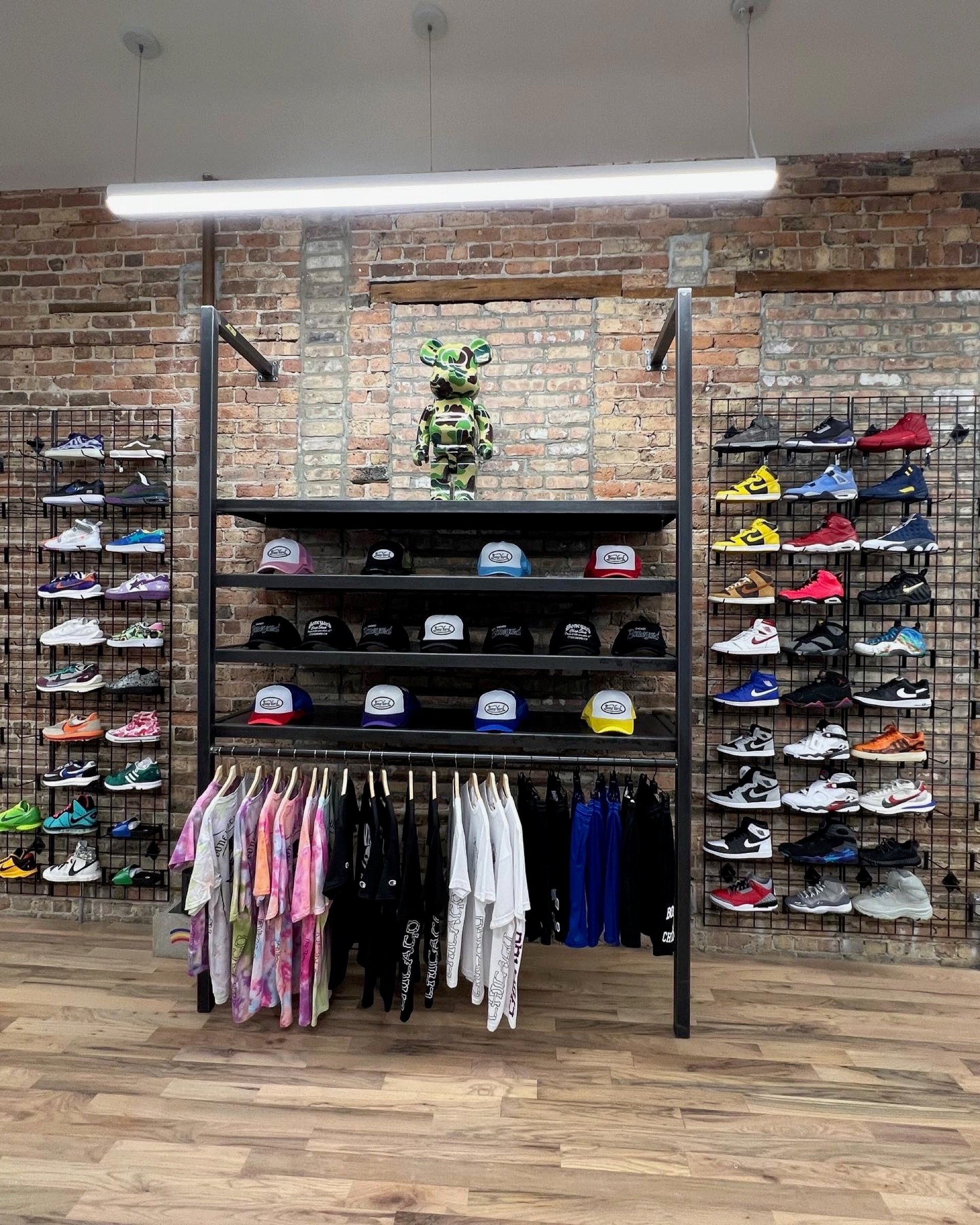 Close view of the central merchandise wall with hats, apparel, and sneaker displays