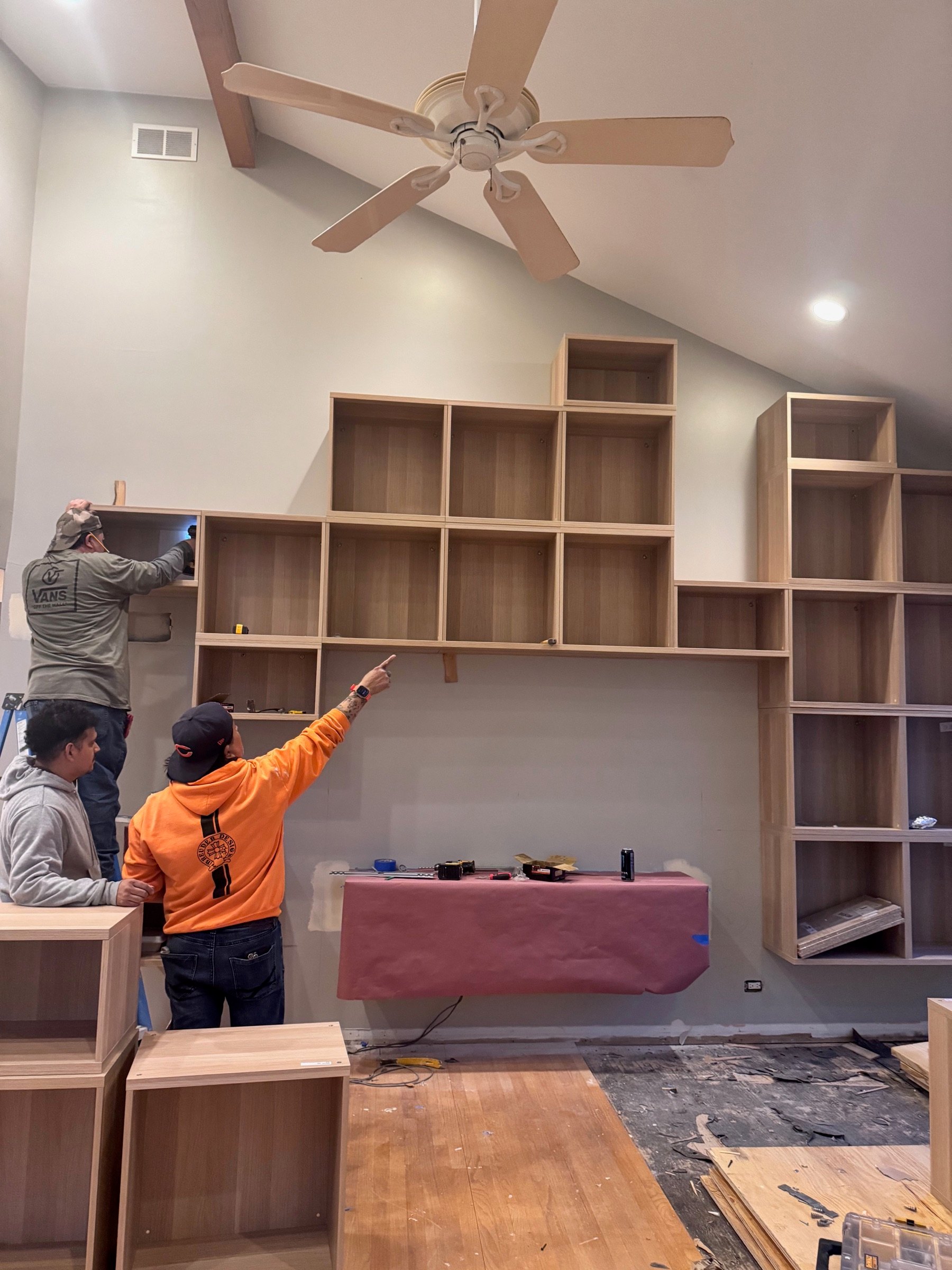 Breuder crew installing custom built-ins on site