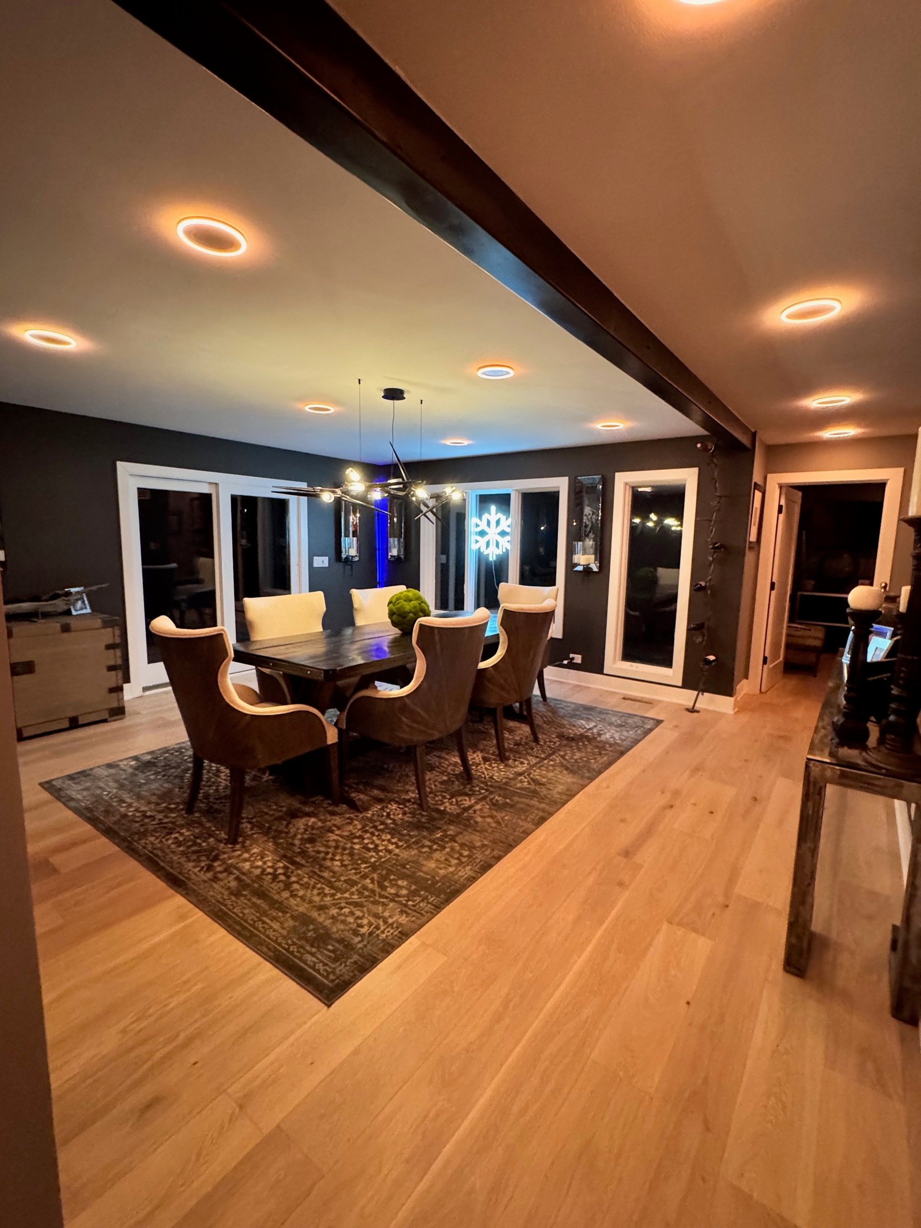 Dining room and kitchen composition opening into one another