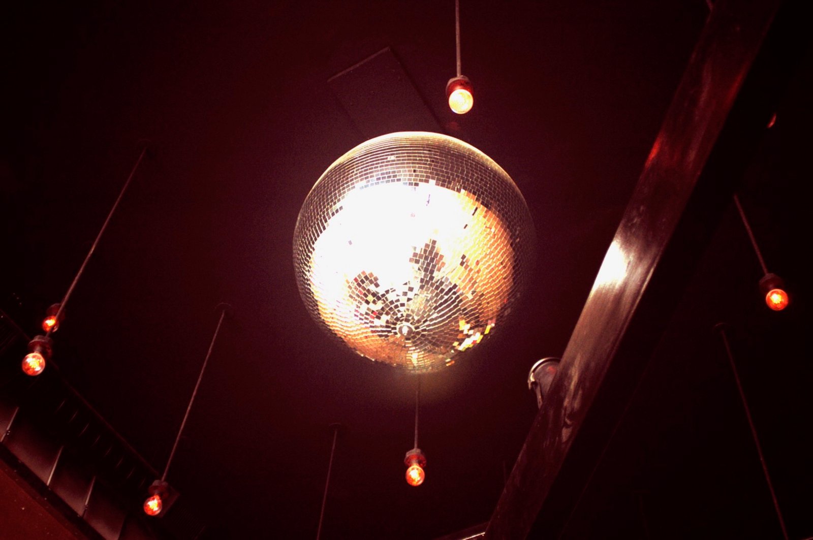 Disco ball and warm pendant lighting over the bar at Blue Bar