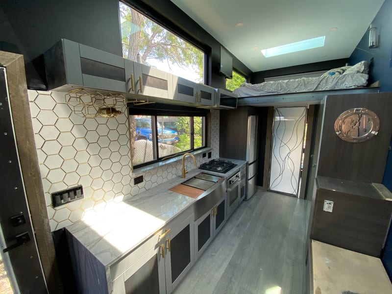 Mini House kitchenette with integrated storage and brass hardware