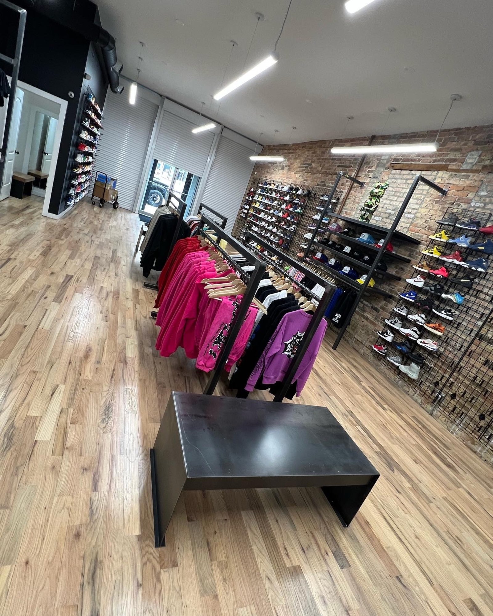 Perspective view across the open sales floor toward the Boneyard counter and feature wall