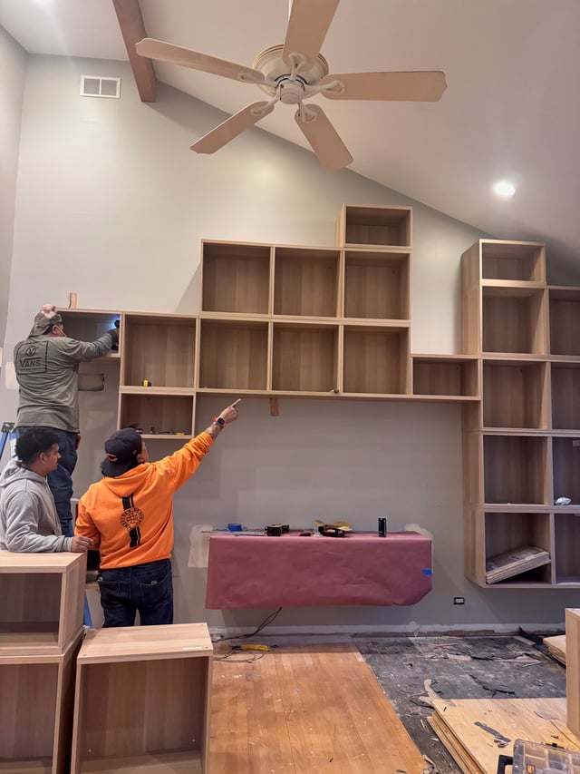 Breuder crew installing custom built-ins on site