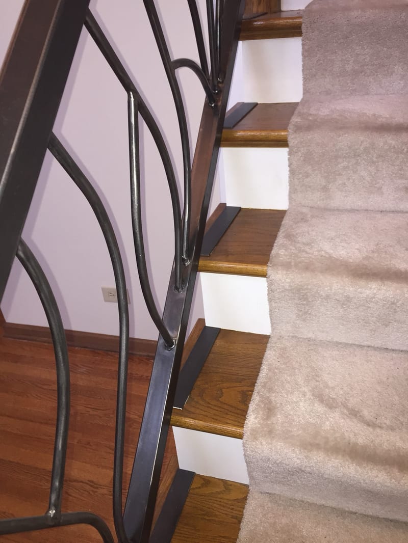 Close view of a sculptural custom metal stair baluster