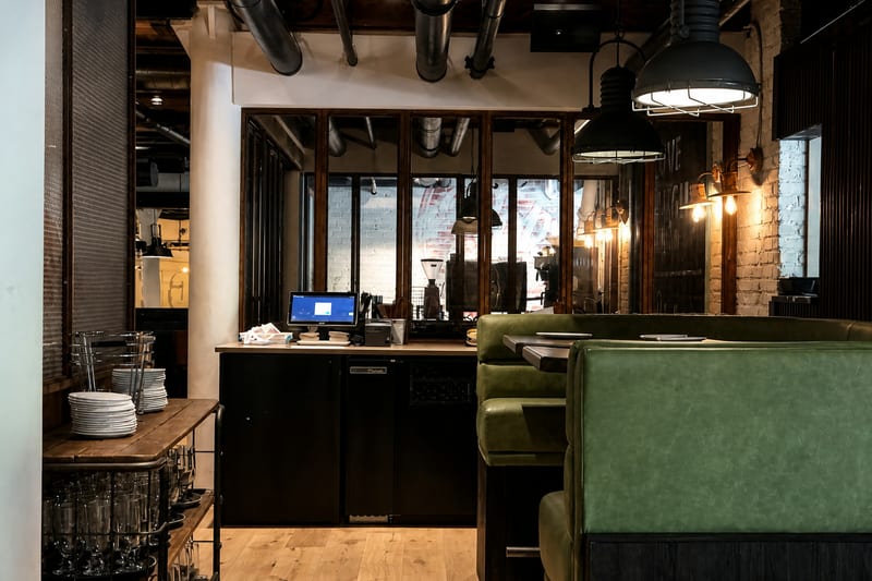 Long view across Blue Bar's lounge seating, service counter, and custom metalwork